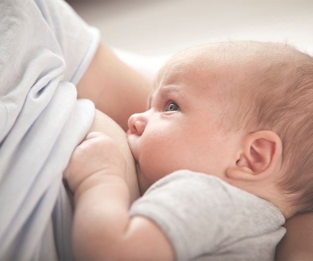 mother breastfeeding newborn baby