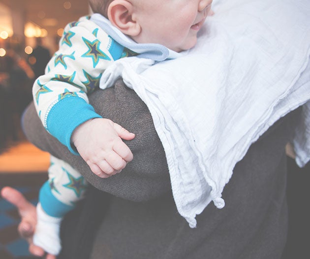 mother burping her newborn baby