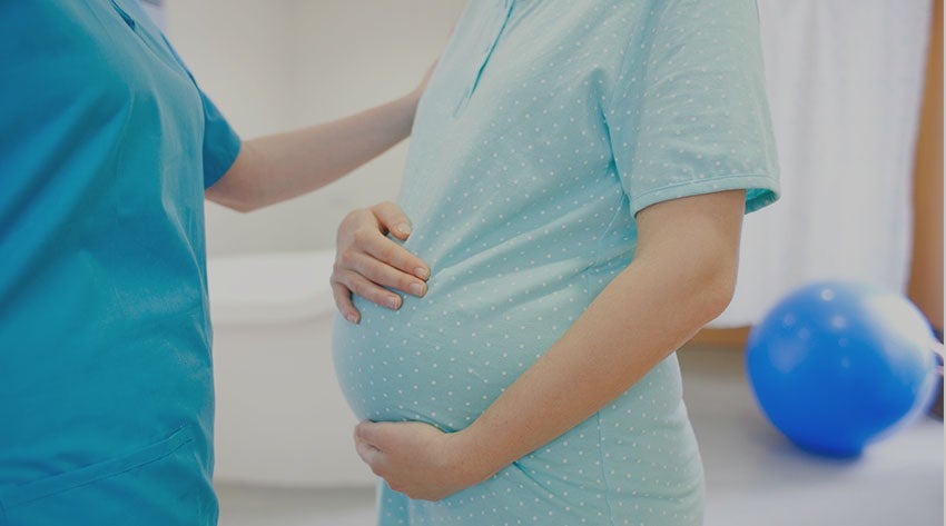 pregnant mother in the delivery room with midwife