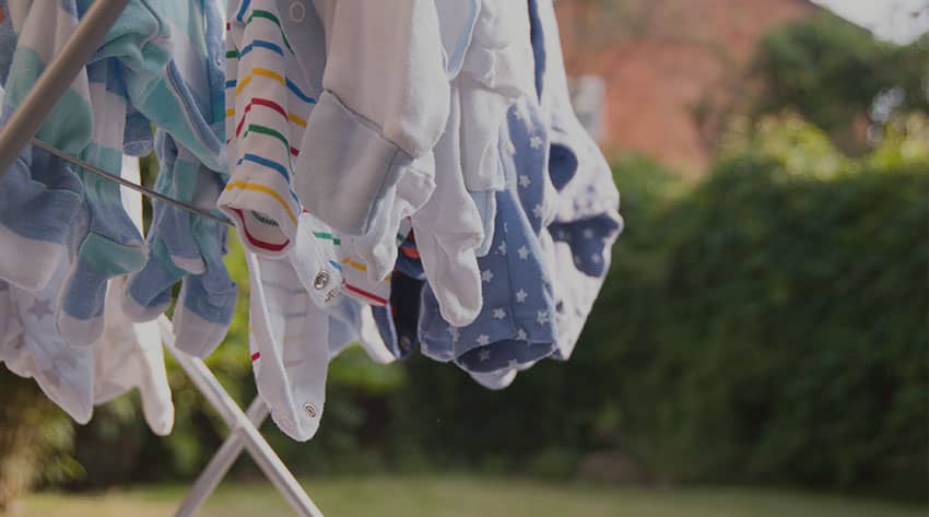 baby clothes on a drying line in the garden
