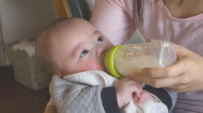 Baby being bottle fed