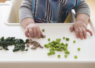 Baby playing with food