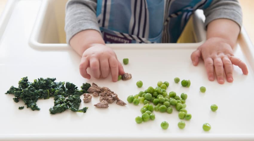 Baby trying finger foods