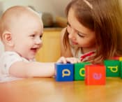 Child playing an interactive game with a toddler