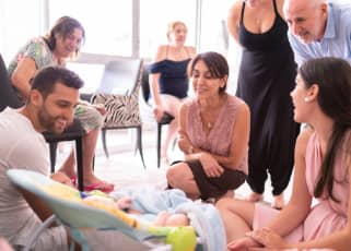 Family gathering around a newborn