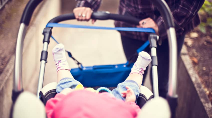 Mum walking with baby on a stroller