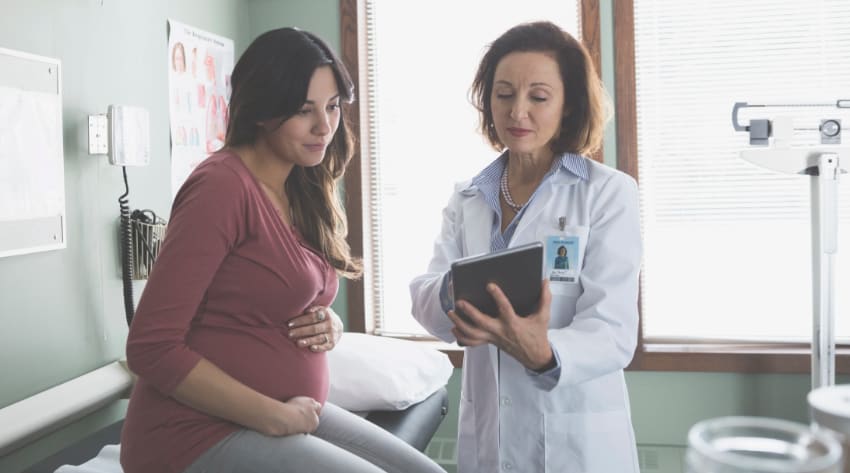 Pregnant mother and midwife at antenatal appointment