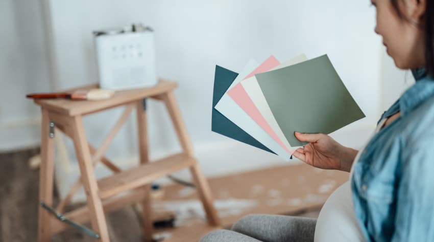 pregnant women holding paint colour charts