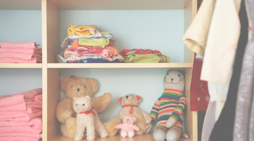 shelves with towels, baby clothes and stuffed animals