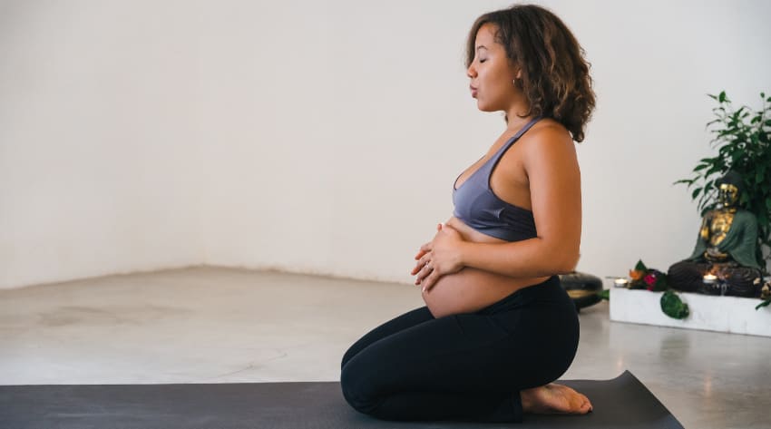 Pregnant mother practicing pregnancy-friendly yoga