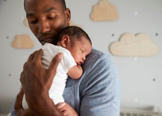 parent holding a newborn baby