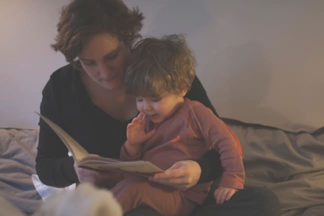 A mother reading a bedtime story to her child