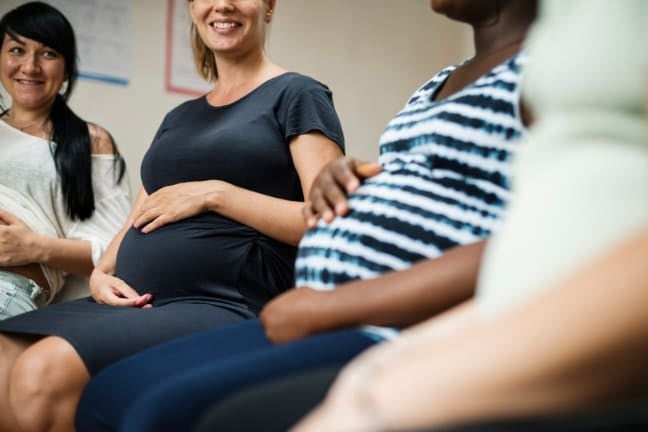 Pregnant women sitting together in a group setting