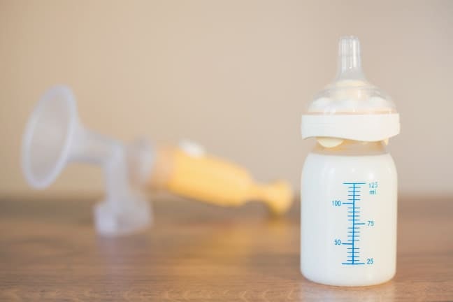 Bottle of expressed breast milk on a table