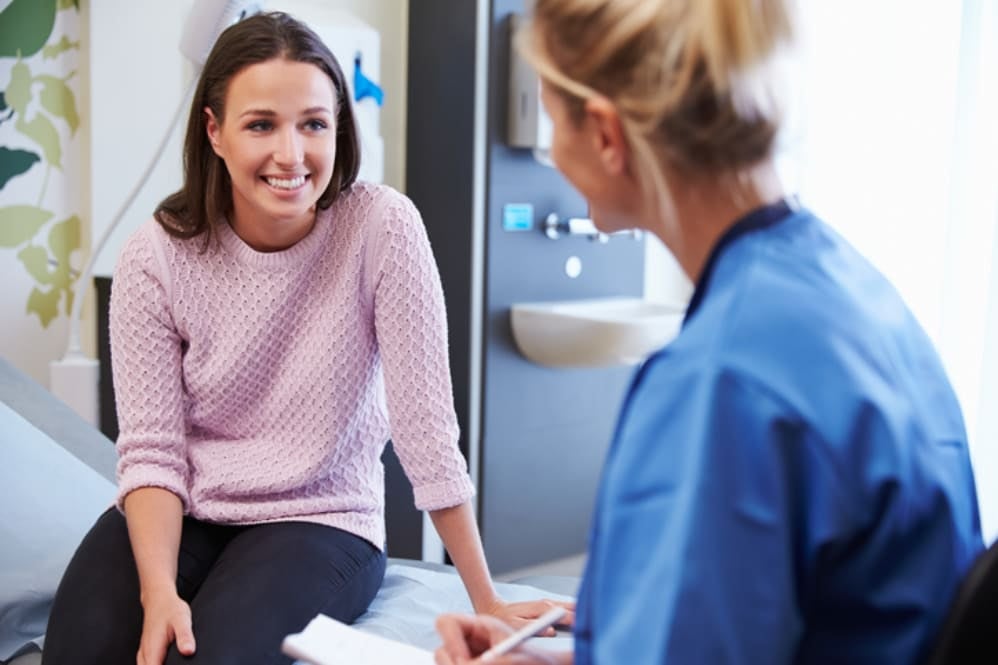 A mother talking to a midwife at her appointment