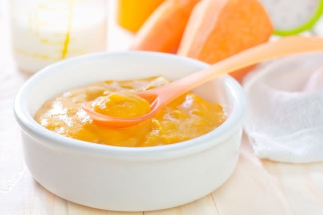 Smooth vegetable purée in a bowl with a spoon, representing early weaning foods for babies