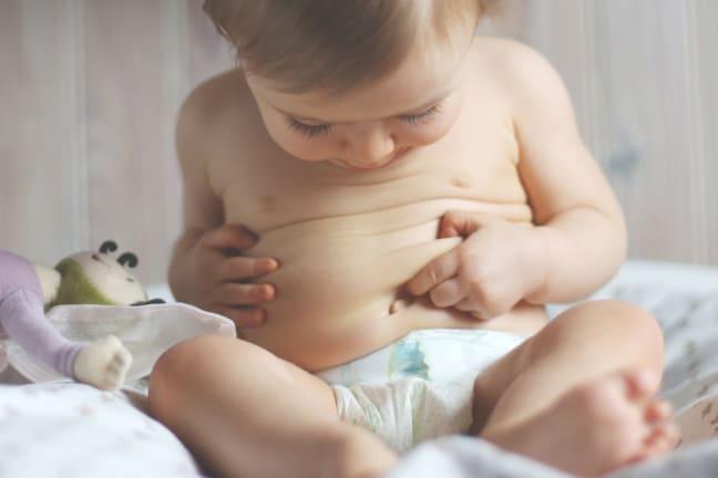 Infant looking at their gut area
