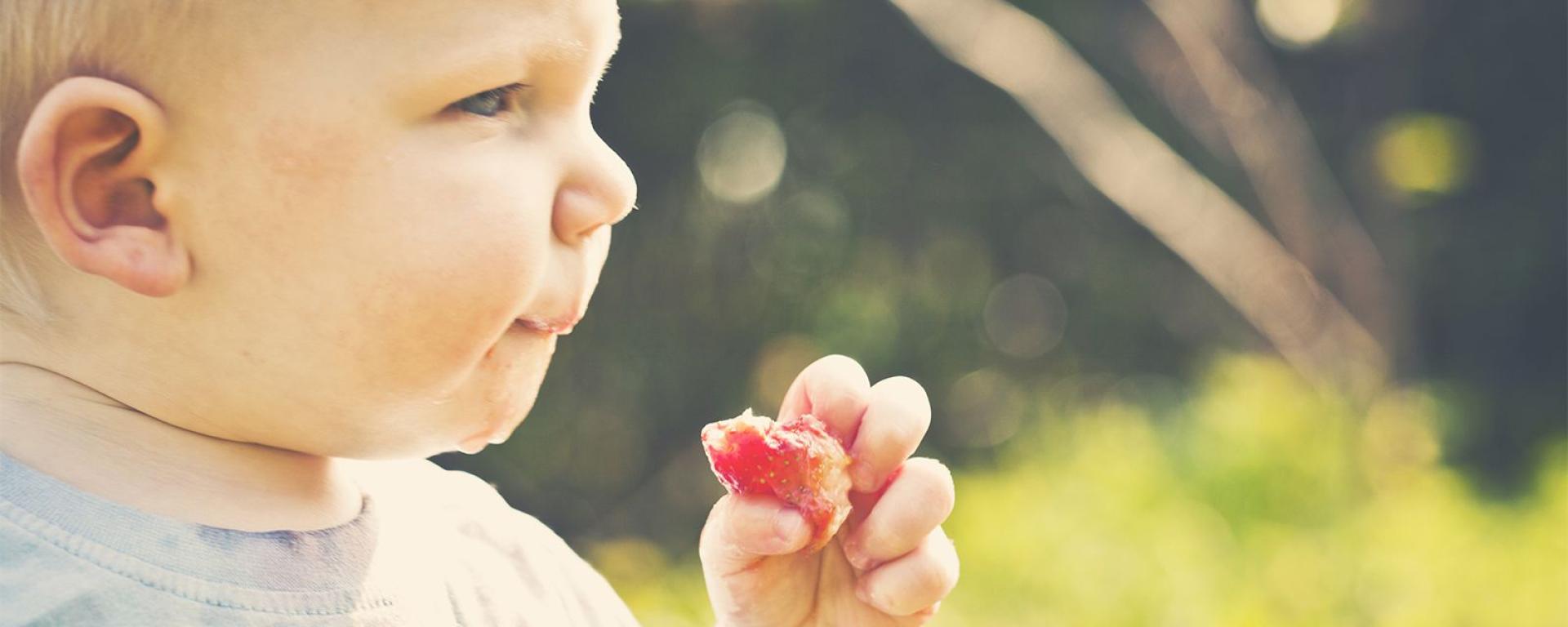 Baby feeding himself using hands