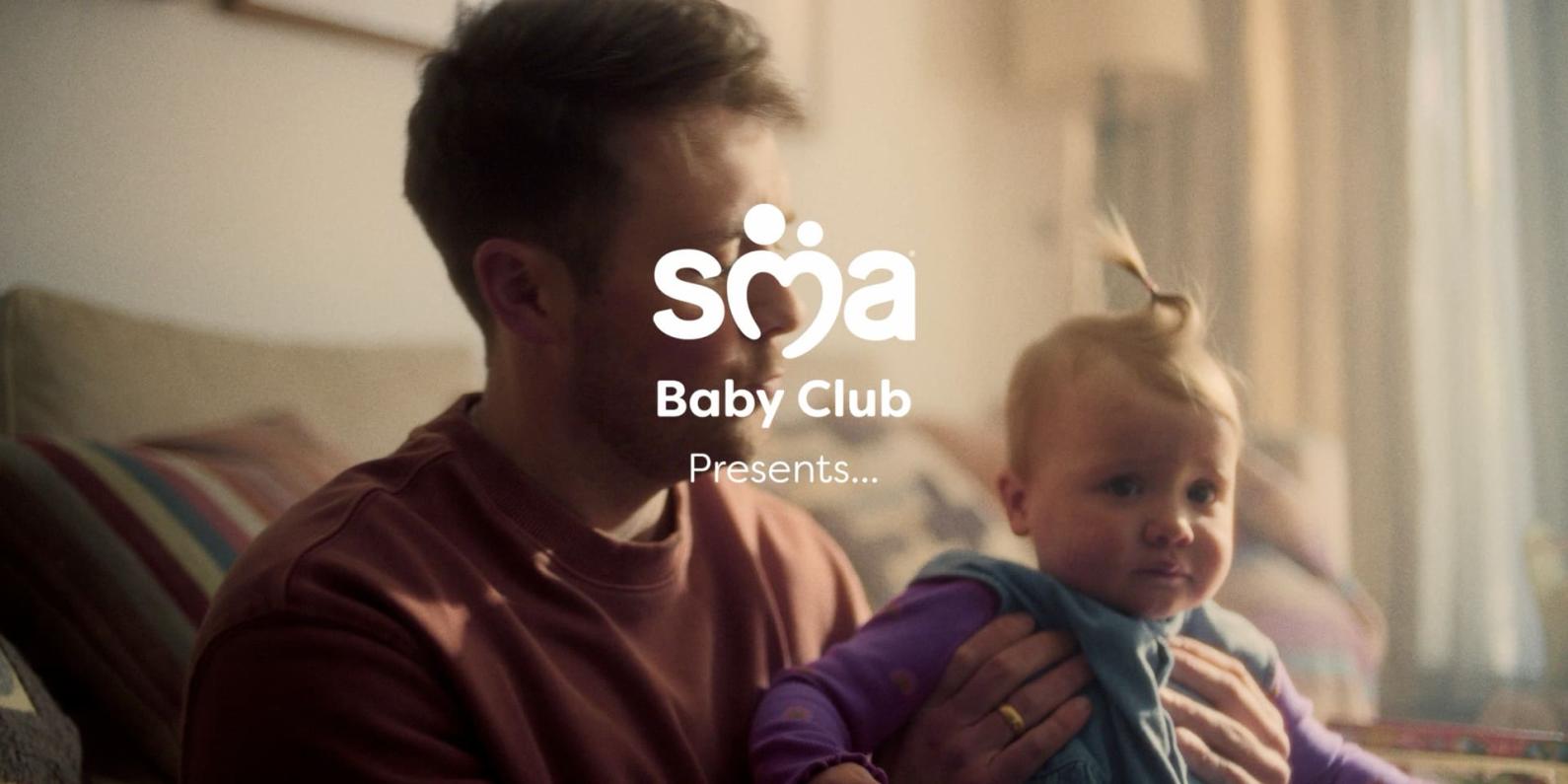 Image of father holding baby with a text overlay of SMA Baby Club presents