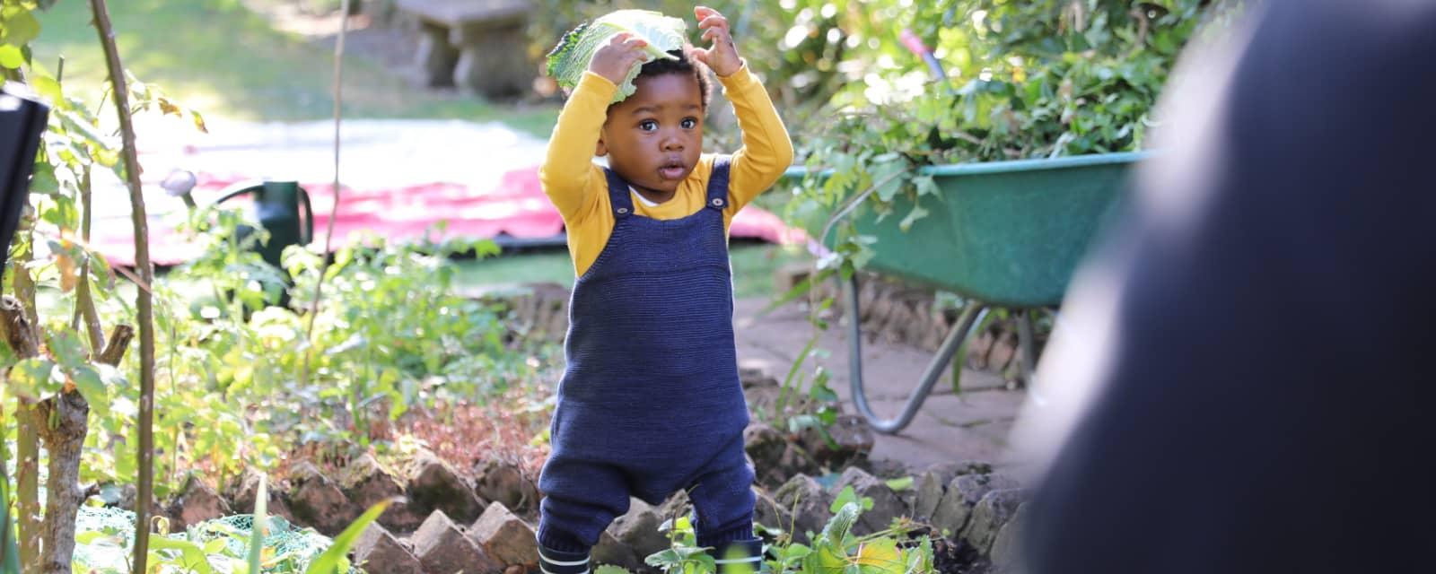 Baby playing in a garden